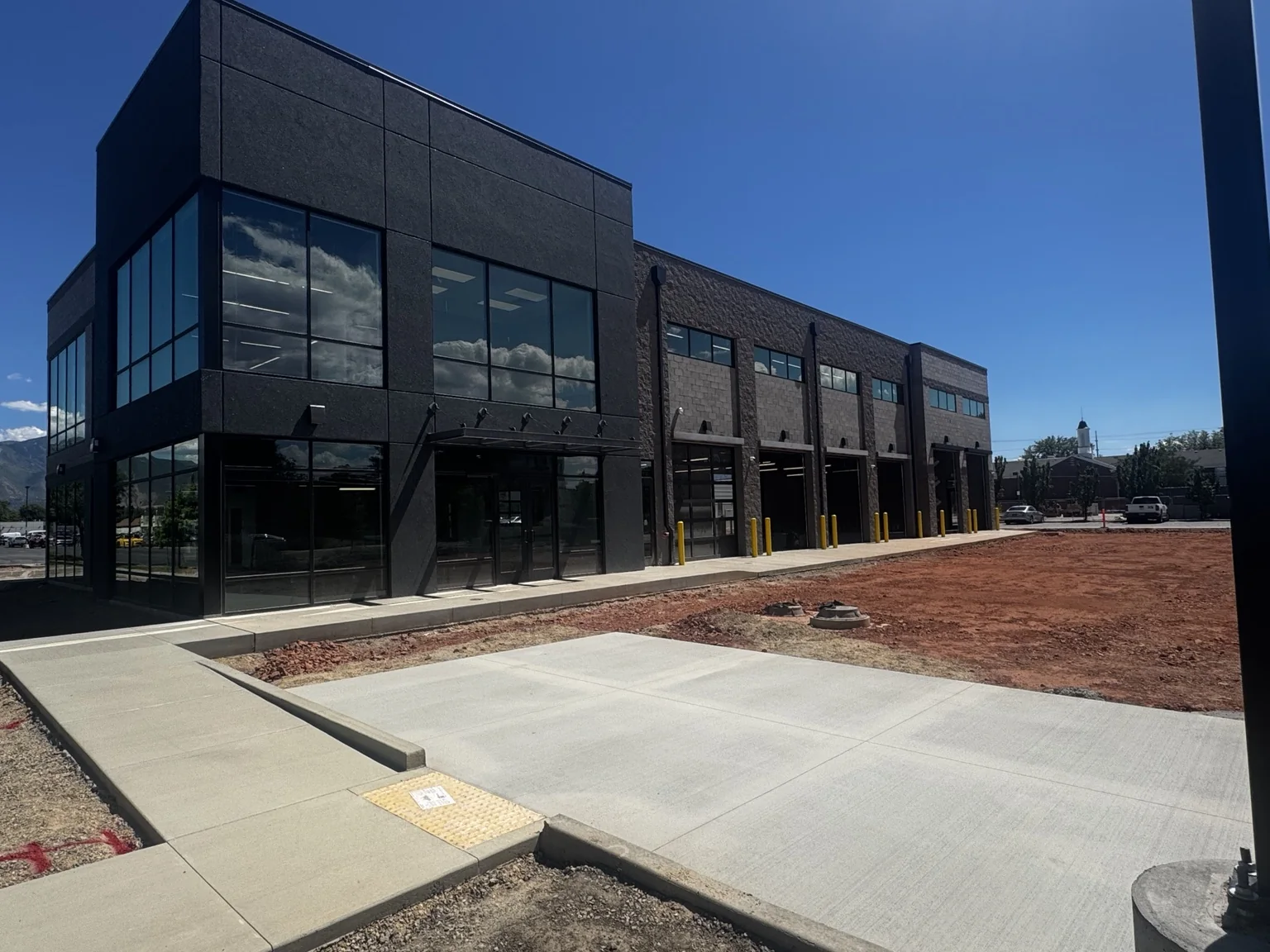 New Big O Tire commercial facility with a glass-front showroom and finished automotive service bays