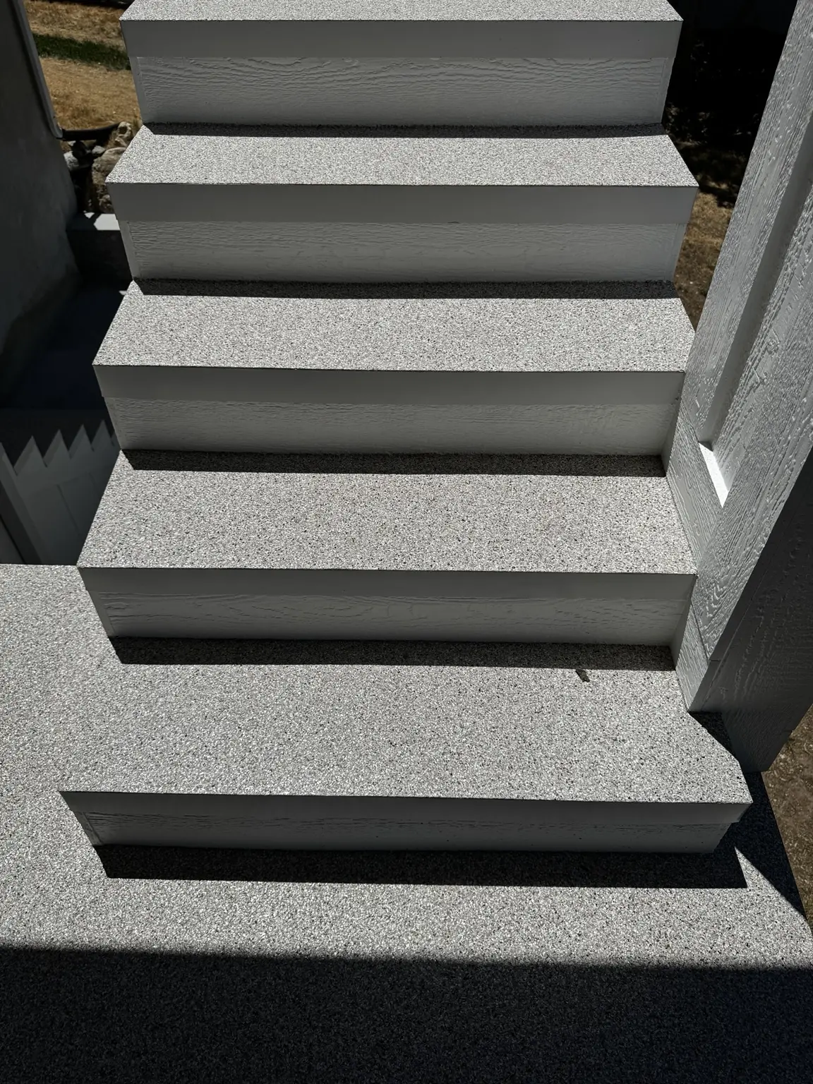 Close-up of coated exterior stairs and consistent tread transitions
