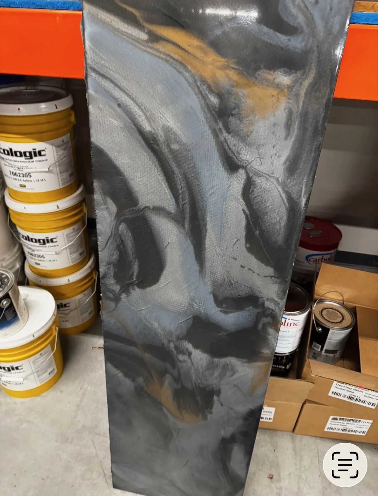 Custom metallic epoxy sample combining silver, charcoal, black, and subtle warm gold accents
